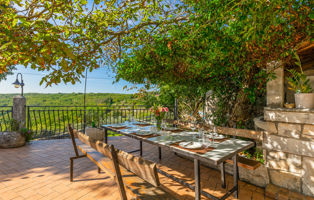 Shaded outdoor dining terrace with fjord views
